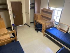 a hospital room with two beds and a desk