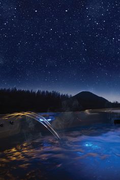 a hot tub with water running under the stars