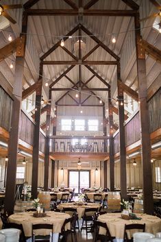 the inside of a building with tables and chairs set up for an event or function