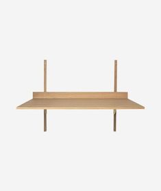 a wooden shelf sitting on top of a white wall