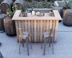 an outdoor bar made out of wooden barrels