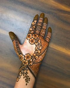 a hand with henna tattoos on it