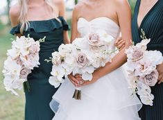 three bridesmaids holding bouquets of flowers in their hands