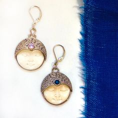 These "divine" sun moon celestial earrings are a rare combination of vintage Sajen Bali goddess moon faces, carved in bone and set in sterling silver, forming a beautiful set of somewhat asymmetrical earrings representing night and day. A tiny gemstone is embedded in the "third eye" of each: a little sparkly pink jewel in the "awake" face, and a deep black stone in the "sleeping" face. This substantial pair of unique earrings are a special statement that can be dressed up or down, and also make a special gift for a woman who loves contemplating the mystical and spiritual. Details -Carved bone set in sterling silver -Diameter of each pendant: approx 1", drop from bottom of wire, approx 1 1/2" -Sterling Silver leverback wires -Comes in beautiful box, ready for gifting Looking for a beautiful Full Moon Energy, Moon Faces, Goddess Moon, Goddess Earrings, Moon Energy, Celestial Sun, Celestial Earrings, Pink Jewels, Asymmetrical Earrings