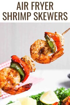 grilled shrimp skewers on a white plate with lemon wedges