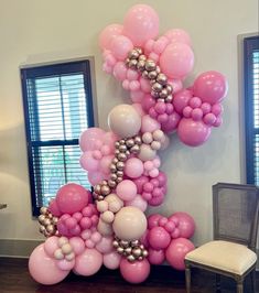 the balloon letter k is made up of pink and silver balloons