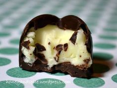 an ice cream filled chocolate heart on top of a polka dot tablecloth with green dots