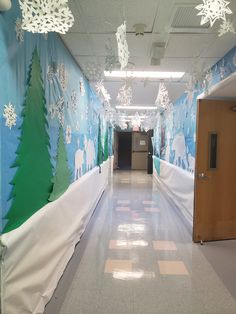 the hallway is decorated with paper snowflakes and trees