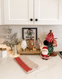 a kitchen counter with christmas decorations and other holiday items on it, including santa clause ornament