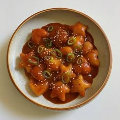 a white bowl filled with food on top of a table