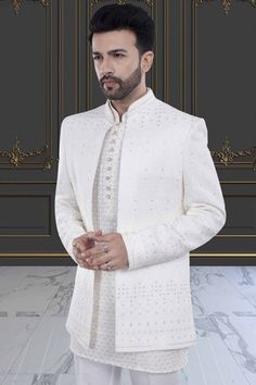 This men's sherwani, featuring elegant sequin and thread work, will elevate any occasion with its open jacket design. The intricate detailing adds a touch of luxury and sophistication. Made with high-quality materials, it is sure to impress with its stunning craftsmanship and modern yet traditional design. Elegant Bandhgala With Resham Embroidery For Festive Occasions, Elegant Embroidered Sherwani For Eid, Elegant Sherwani With Chikankari Embroidery For Diwali, Elegant Suits With Dabka Work For Reception, Elegant Nehru Jacket With Chikankari Embroidery For Reception, Elegant Dabka Work Suit For Reception, Elegant Nehru Jacket With Intricate Embroidery For Festive Season, Elegant Bandhgala With Dabka Work For Festive Occasions, Elegant Festive Bandhgala With Dabka Work