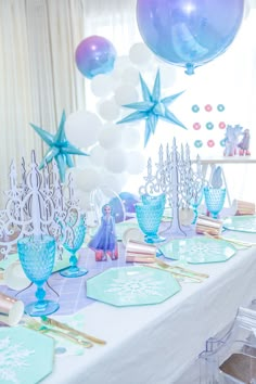 a table topped with lots of blue and white decorations