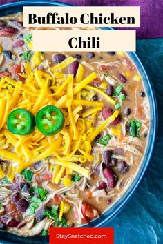 instant pot buffalo chicken chili with cheese and jalapenos in the middle on a blue plate