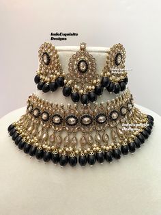 Antique Gold Polki Necklace Set comes with Stud earrings and tikka / Indian Jewelry/ High Quality Kundan and Polki Jewelry/ Bollywood Jewelry/Wedding Jewelry/Black color    All items are shipped from Brampton, Ontario, Canada. If you need your item by a certain day, please reach out to us for express delivery option before placing the order so that we can update the shipping for you. Standard shipping/delivery timeline Below are the delivery timeline estimates once the order ia shipped ---> USA delivery timeline * 3-5 business days to major urban centers in USA. It may take 1-2 days extra to remote locations ---> Canada delivery timeline  * 2-3 business days - GTA  & Montreal  * 2-4  business days - Rest of Ontario/Quebec * 3-6 business days-  Rest of Canada    ---> Europe/Middle East time Luxury Bollywood Chandbalis For Navratri, Black Jewellery Set, Black Necklace With Latkans For Festive Occasions, Festive Black Necklace With Latkans, Festive Black Necklaces For Celebration, Festive Black Beads Celebration Jewelry, Traditional Black Meenakari Jewelry, Black Kundan Necklace For Festivals In Temple Jewelry Style, Black Chandbali Temple Jewelry