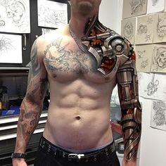 a man with tattoos on his chest and arm