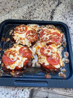 several slices of pizza sitting on top of a pan covered in cheese and pepperoni