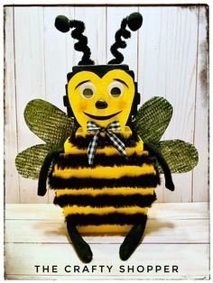 the crafty shopper bee is wearing a black and yellow striped shirt