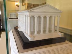 a model of the united states building on display in a glass case at a museum