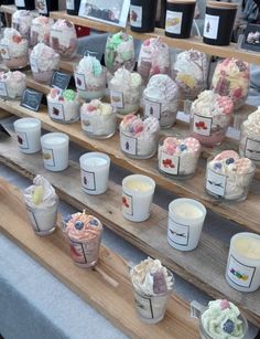 cupcakes and candles are on display for sale