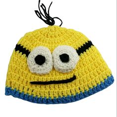 a crocheted yellow and blue hat with eyes