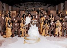 a large group of people posing for a photo in front of a wedding arch with the bride and groom