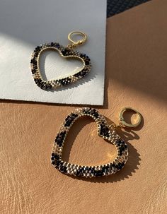 Make a playful statement with these heart shaped hoop earrings that will leave you feline fabulous. (Sorry, couldn’t help myself!). These intricately hand beaded leopard print earrings will not fail to put a smile on your face! And because the beads are so delicate, these earrings are light-weight, too!I have carefully chosen a mix of sparkling and metallic beads to create extra texture to the leopard print pattern. Hand beaded by Sadie with the highest quality glass seed beads and 24 carat gold Party Hoop Heart Earrings For Pierced Ears, Party Hoop Heart Earrings, Trendy Heart Hoop Earrings For Party, Trendy Heart-shaped Hoop Earrings For Party, Heart-shaped Metal Hoop Earrings For Parties, Heart-shaped Beaded Earrings For Party, Heart-shaped Beaded Party Earrings, Gold Heart Beaded Earrings For Party, Gold Heart Shaped Beaded Earrings For Party