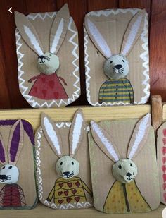 four paper bags with rabbits on them and one has an image of two people in the middle