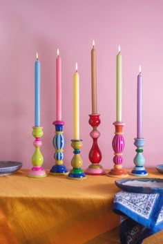 colorful candles are lined up on a table