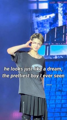 a person standing in front of a blue screen with a quote on it that says he looks just like a dream, the prettiest boy i ever seen