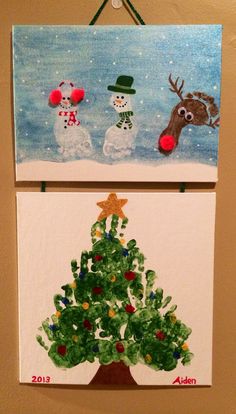 two christmas paintings hanging on the wall