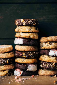 a stack of cookies with white icing and peppermint on top sitting on a table