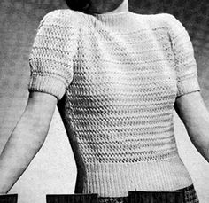 an old photo of a woman wearing a sweater