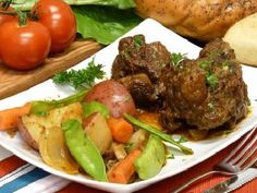 a white plate topped with meat and vegetables