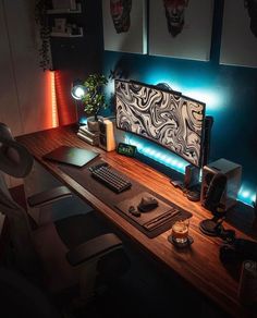 a desk with a computer, keyboard and mouse on it in a room that has blue walls