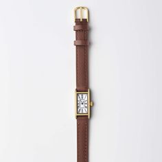 Reminiscent of a tied ribbon, the streamlined silhouettes of yesteryear gave inspiration for this romantic double tour leather strap. This one's in the perfect nut-brown neutral—out go-to when black feels too formal. Small Gold Watch, Gold Watch For Women, Women March, Minimal Watch, Tied Ribbon, March Hare, Small Watch, Brown Watches, Vintage Timepiece