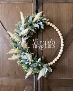 a wreath on the front door of a house with words virginia's treasures above it