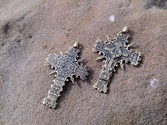 "A copy of the historical findings. The Cossack cross. 16-18 century Description: Double-sided pendant Metal: bronze or silver 925 Weight: approx. 9 g Size: approx. 5,5 x 3,4 cm \\ 2,16\" x 1,33\" Hole size: 2 mm \\ 0,07'' The product will be shipped complete with a cotton cord black color. *The color of real item may be a little different from the pictures due to the display of screen. Bronze - metal, which over time can oxidize and darken on the air. All my creations are intentionally patinate Byzantine Cross Necklace With Engraving, Handmade Bronze Cross Pendant Necklace, Handmade Bronze Necklace With Cross Pendant, Antique Brass Cross Pendant Necklace, Bronze Cross Pendant Necklace For Gift, Handmade Medieval Cross Jewelry, Antique Bronze Cross Necklace, Antique Bronze Cross Pendant Jewelry, Bronze Engraved Cross Necklace