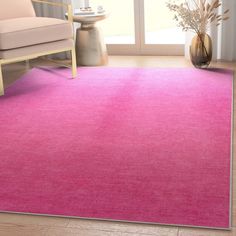 a bright pink rug in a living room