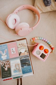 headphones, books, and other items are on the floor next to each other