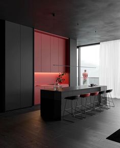 a modern kitchen with black and red accents