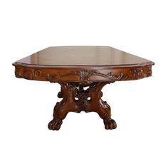 an ornate wooden table with glass top