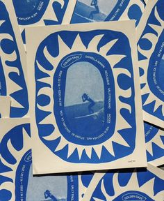 some blue and white stickers with a person on a surfboard in the middle