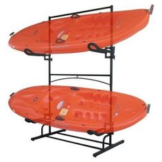 two orange kayaks sitting on top of each other in front of a white background