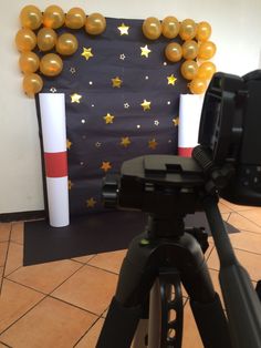 a camera is set up in front of a wall with stars and balloons on it