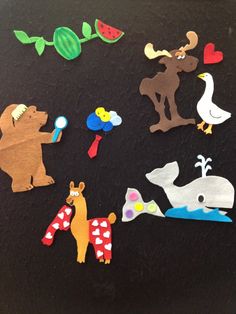 various cut out animals and birds on a black surface