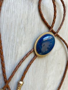 This awesome bolo tie has a southwestern design and blue agate centerpiece. Each of our stones is unique . The cord is genuine brown leather. It has a gold metal frame and matching gold tips. Our bolos pair nicely with many of our belt buckles! They make wonderful gifts. The western bolo tie rope length is 100cm(39") ; charm agate stone pendant size is 5*4cm(1.97*1.57in) Adjustable Gold Western Bolo Ties, Adjustable Gold Concho Jewelry, Gold Western Bolo Tie, Vintage Gold Jewelry For Rodeo, Adjustable Southwestern Gold Jewelry, Adjustable Western Gold Jewelry, Adjustable Gold Western Jewelry, Blue Lariat Bolo Tie For Gift, Elegant Adjustable Concho Bolo Ties