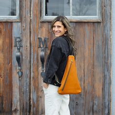 "The Triangle Sling Bag is a fun new design, convenient & perfect for all seasons! Wear her on your back, in front, or on your shoulder. Honey Brown Leather Black Leather Strap Brass Hardware ... * Fast & FREE USPS Shipping * Made with Full-Grain leather * Interior key-clip * YKK zipper closure * 11\"W at base x 18\"H x 1\" deep * Adjustable strap * Made to order in Bellingham, Washington Questions? Contact me before placing your order!" Traditional Bags, Leather Sling Bags, Bellingham Washington, Travel Women, Leather Sling Bag, Functional Fashion, Honey Brown, The Triangle, Women Travel