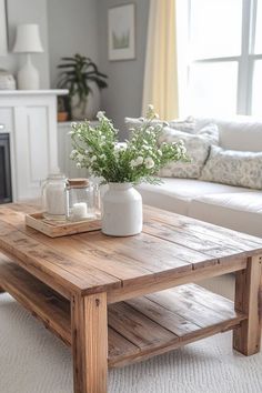 a living room with a couch, coffee table and vase on the top of it