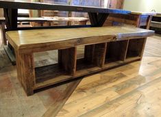 a wooden bench sitting on top of a hard wood floor