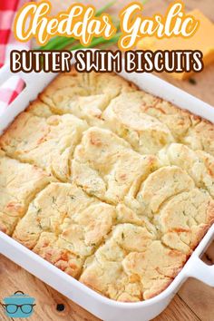 a white casserole dish with buttery biscuits in it and text overlay reading cheddar garlic butter swim biscuits